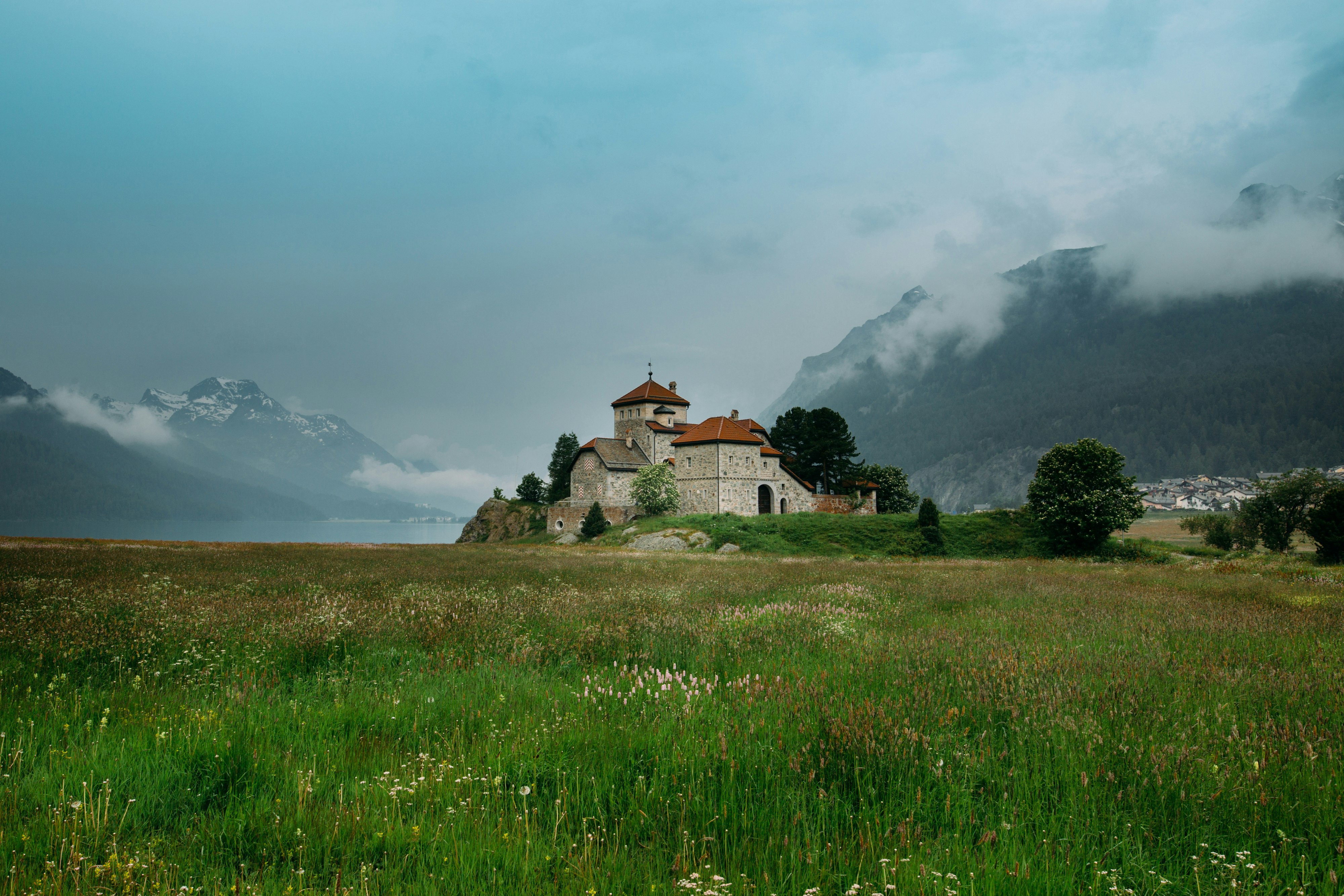 beige concrete house on grass fields